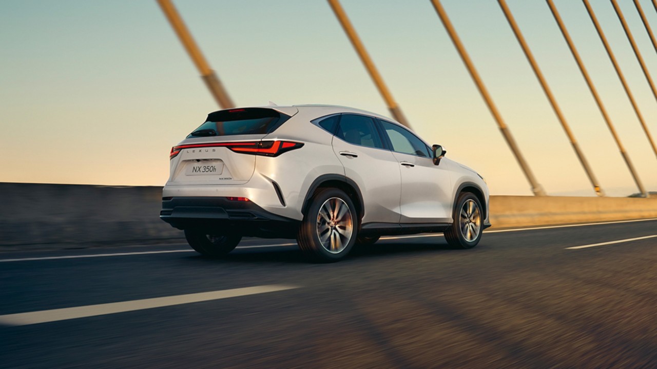 Lexus NX 350h driving across a bridge