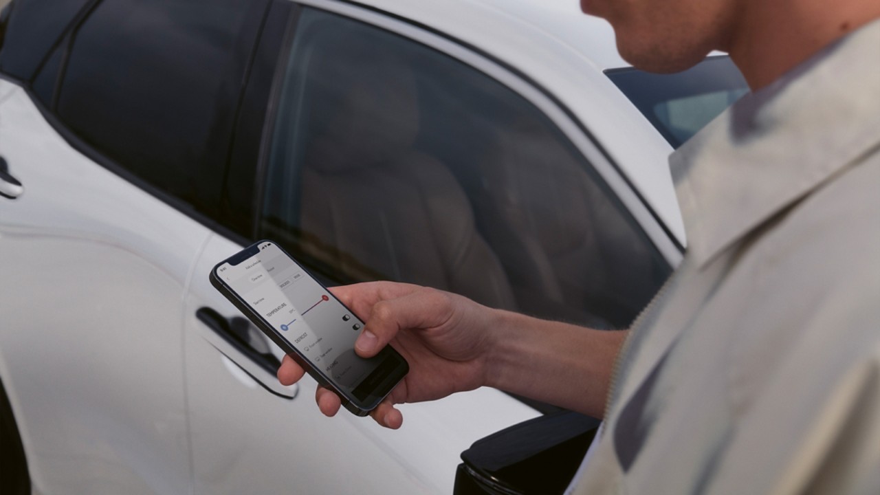 A person using a mobile phone to access the Lexus Link+ app